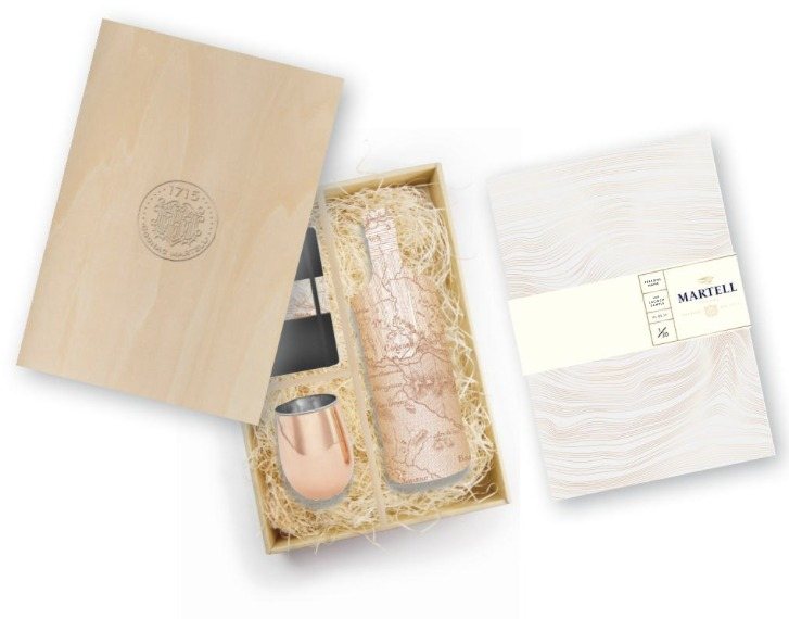 The Martell VS Single Distillery press pack: wooden box, bottle wrapped in a topographic map, copper cup and contour-line book
