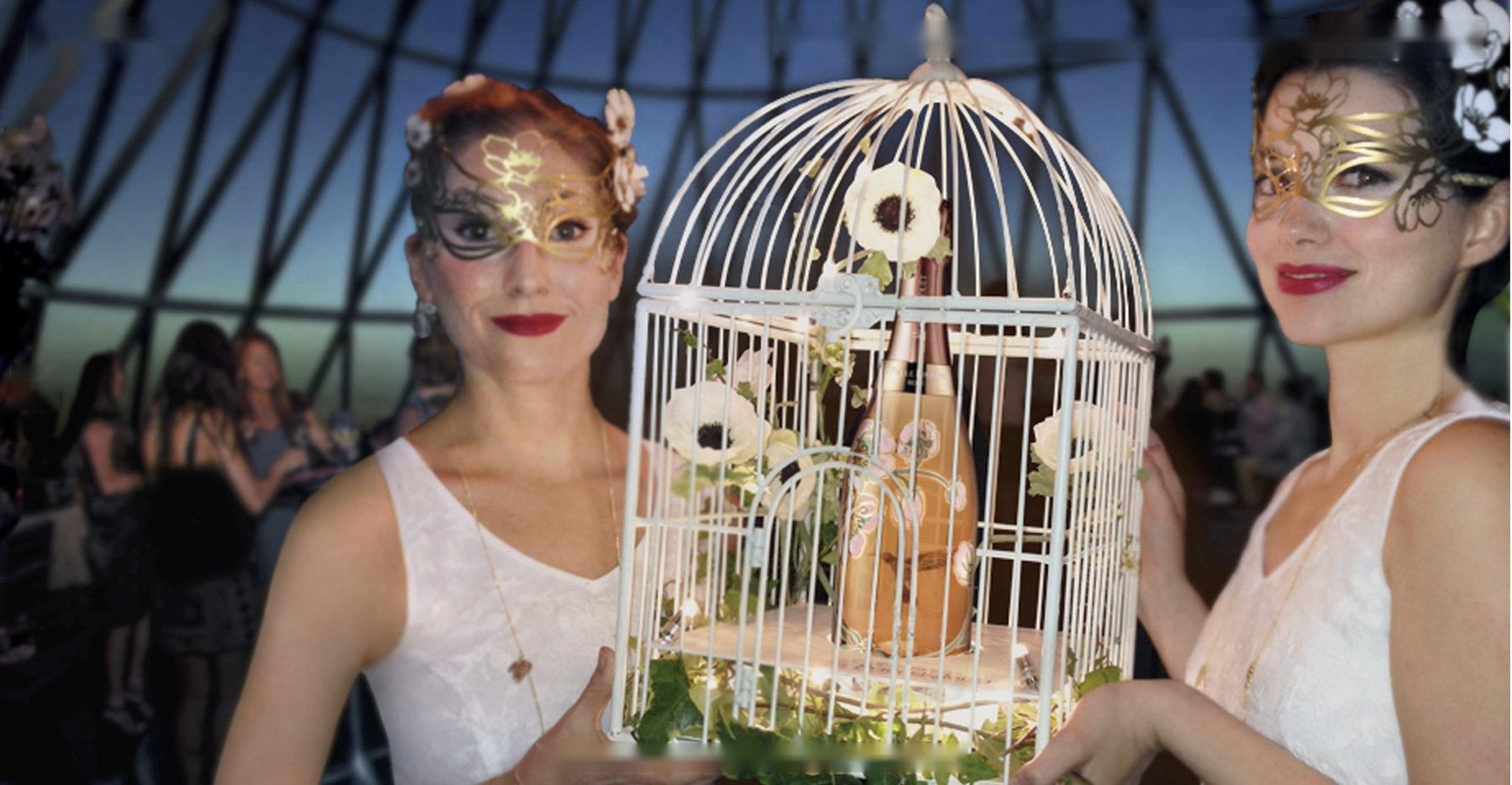 The birdcage serve, with guests in anemone masks under the dome
