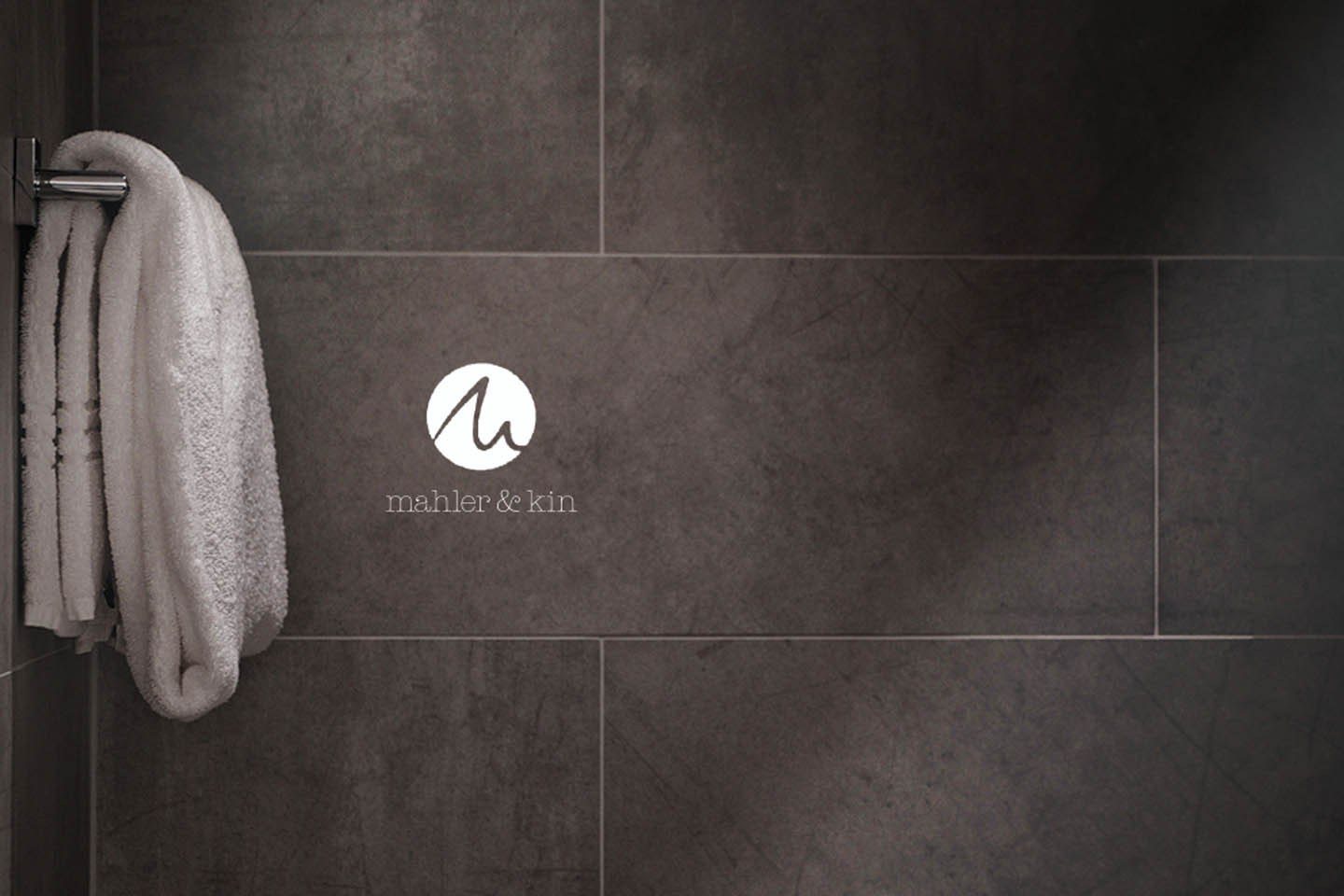 The Mahler & Kin logo on dark tiles
