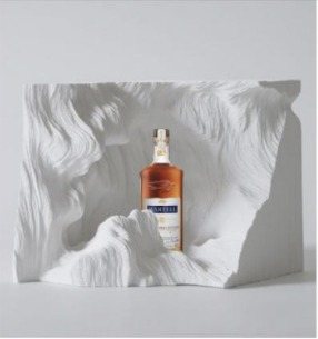 Art installation concept: the bottle set in a sculpted white landscape