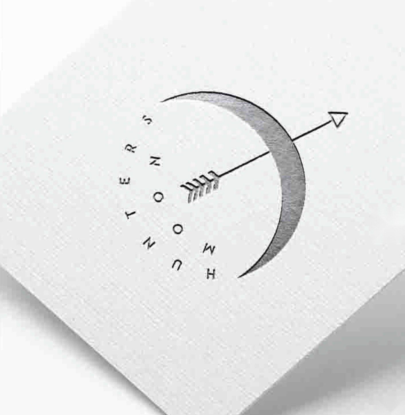 The embossed crescent-and-arrow mark